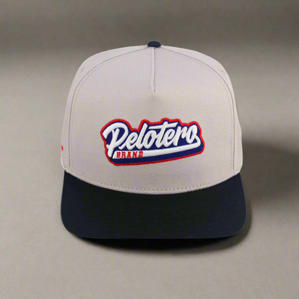 Beige and black cap with 'Pelotero Brand' logo on a white background