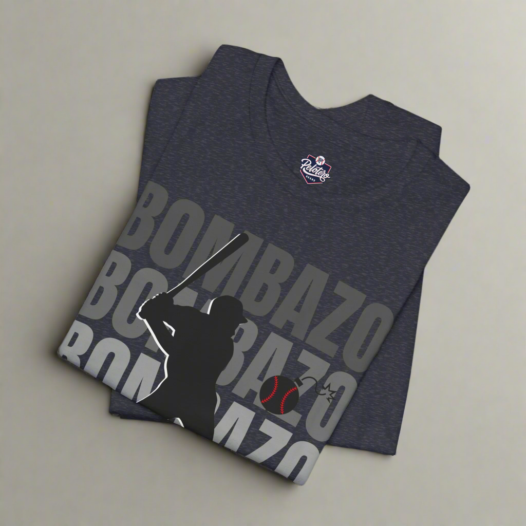 Folded dark gray t-shirt with 'Bombazo' text and silhouette design on a white background