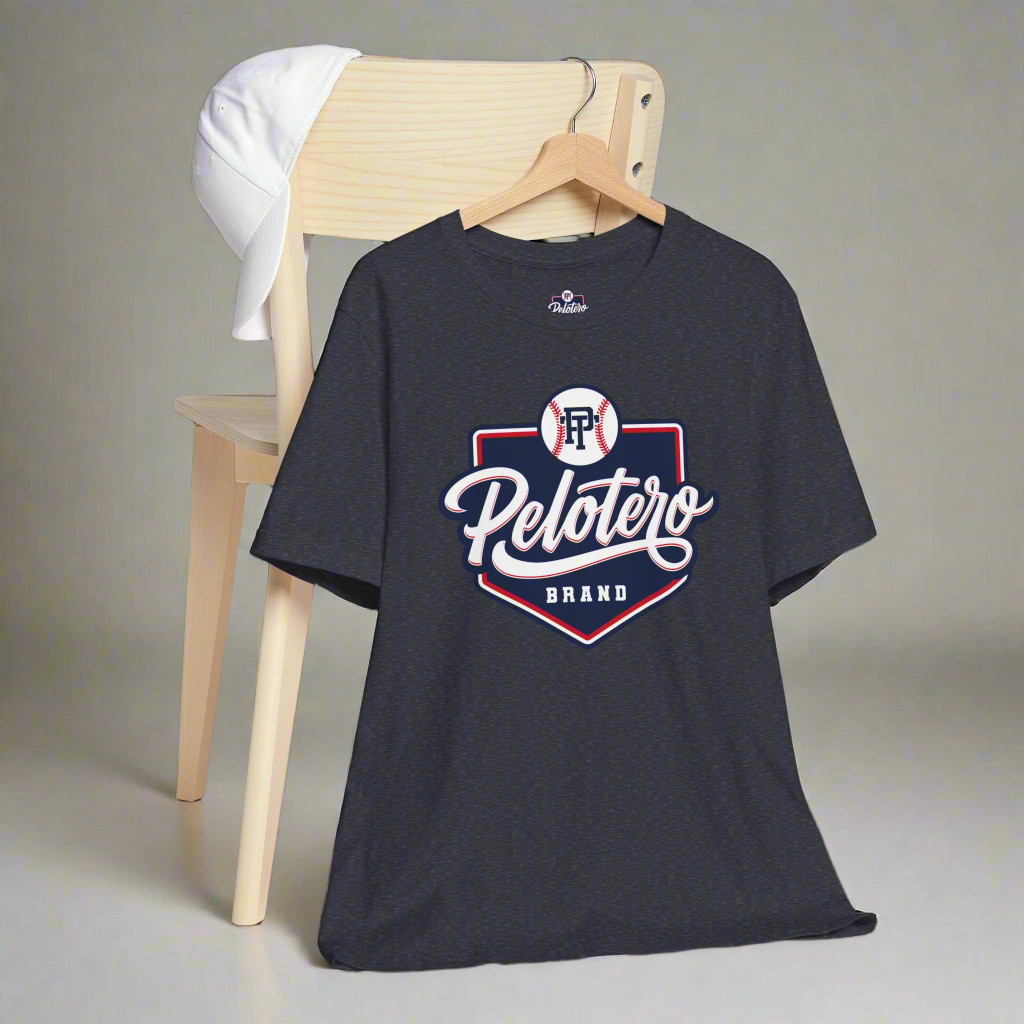 Black t-shirt with 'Pelotero Brand' logo on a wooden chair against a gray background