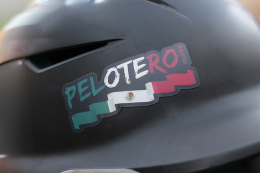 Helmet with a 'Pelotero' sticker on a dark background