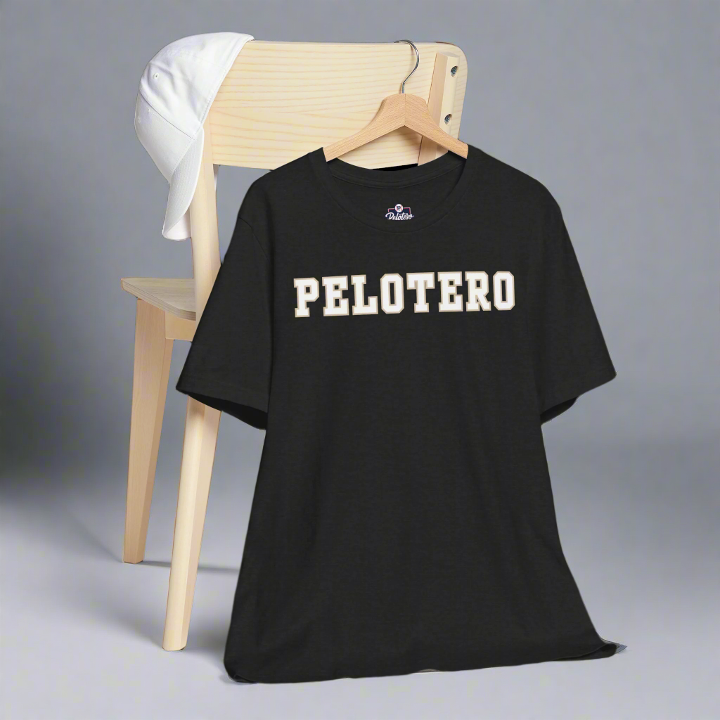 Black t-shirt with 'PELOTERO' text on a hanger against a gray background