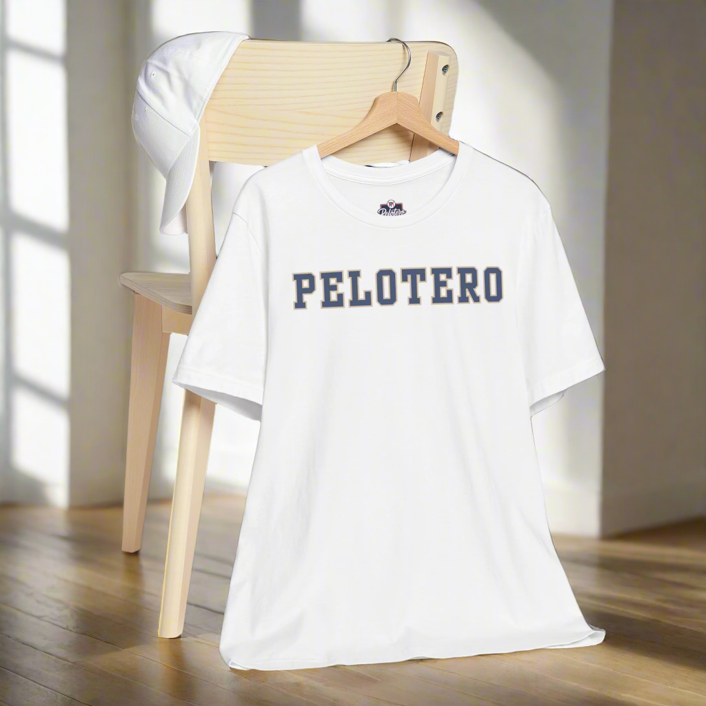 White t-shirt with 'PELOTERO' text on a wooden chair against a gray background
